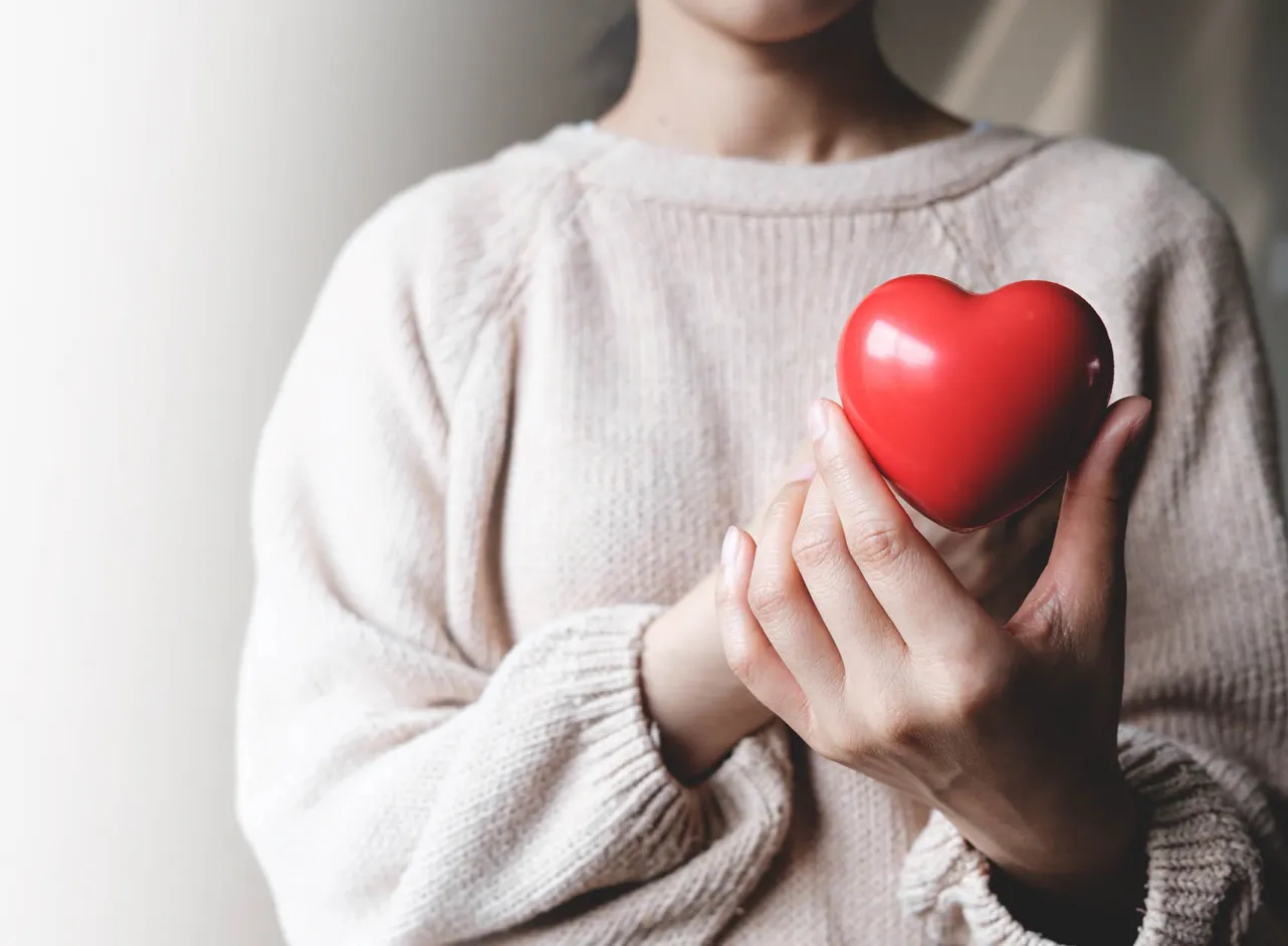 woman holding red heart 